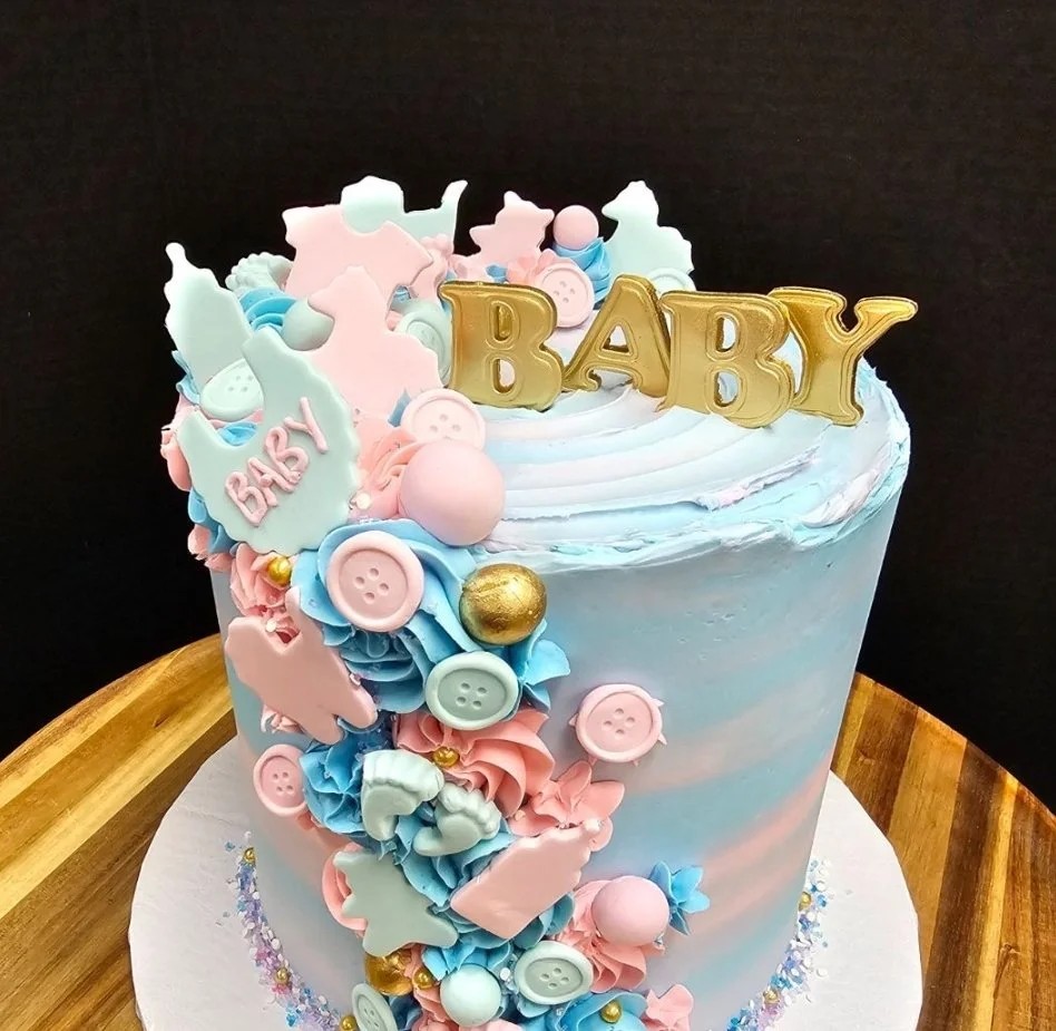 Cute baby shower cake with pastel decorations